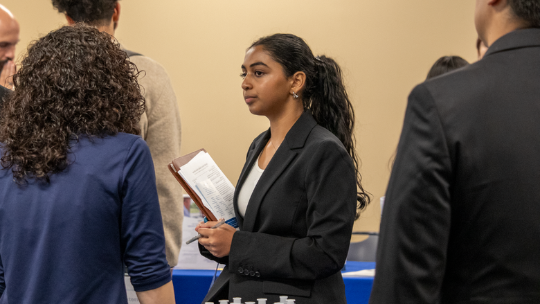 a female student speaking with an employer 